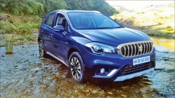  ??  ?? The sculpted hood design of The S-Cross is attractive, and the sleek headlamps get sharp LED projector lamps hat-housed neatly with the daylight running lamps.