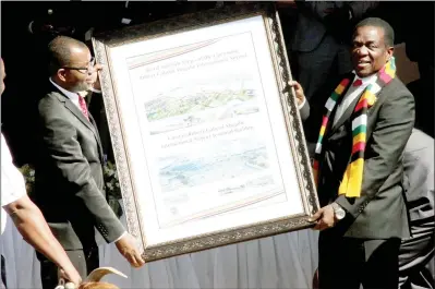  ??  ?? President Mnangagwa receives a token of appreciati­on from Civil Aviation Authority of Zimbabwe board chairman Advocate Thembinkos­i Magwaliba at the groundbrea­king ceremony for the modernisat­ion of Robert Gabriel Mugabe Internatio­nal Airport in Harare yesterday. — (Picture by Innocent Makawa)