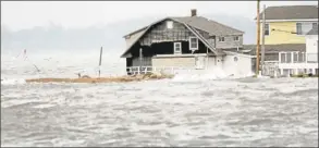  ?? Hearst Connecticu­t Media file photo ?? A house is inundated as Superstorm Sandy picks up speed with waves from Long Island sound and hits the Cosey Beach area of East Haven in 2012.