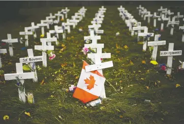 ?? NATHAN DENETTE / THE CANADIAN PRESS ?? Crosses are displayed in memory of those who died from COVID-19 at the Camilla Care Community facility during the COVID-19 pandemic in Mississaug­a, Ont. The majority of Canadian COVID deaths have been among the elderly.
