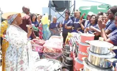  ?? ?? First Lady Dr Auxillia Mnangagwa looks at detergents being made by women she trained and an assortment of household goods they bought to share among themselves from proceeds of projects she initiated for women in Chirumhanz­u-Zibagwe constituen­cy during her tenure as their legislator 10 years ago