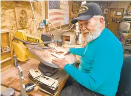  ?? SHELEILEE SULLIVAN VIA THE WASHINGTON POST ?? Mike Sullivan carves some of the toys he and his wife Judy donate each year. The Desert Hot Springs couple makes about 1,500 toys each year.