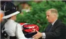  ??  ?? Chris Patten receives a folded British flag after its lowering at Government House in Hong Kong, June 1997. Photograph: Eric Draper/AP