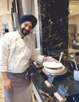  ??  ?? Chef Oberoi at the street food station at the Taj Palace hotel.