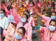  ?? Money Sharma / AFP / Getty Images ?? Community health workers rally in New Delhi to demand higher pay and more protective equipment.