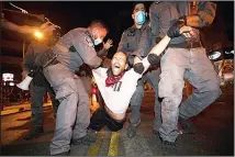  ?? 1. (AP) ?? Israeli police officers detain an Israeli protester during a demonstrat­ion against lockdown measures that they believe are aimed at curbing protests against Prime Minister Benjamin Netanyahu in Tel Aviv, Israel
on Oct