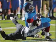  ?? DANA JENSEN/THE DAY ?? Waterford’s Marcus Lovell, right, looks downfield as he attempts to twist away from the tackle by Montville’s Ryan Champagne on Thursday.