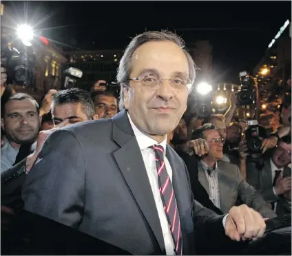  ?? PASCAL ROSSIGNOL/ REUTERS ?? Conservati­ve New Democracy leader Antonis Samaras leaves the party’s main election office in Athens’ central Syntagma square Sunday. Samaras claimed victory in the national election, saying Greeks had voted to stick with the euro single currency.