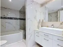  ??  ?? LaVie condo units have two bathrooms each, one an ensuite with a wallto-wall shower. The main bathroom has a bathtub and shower with Italian porcelain and glass mosaic tile trim.