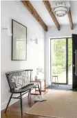  ??  ?? HALLWAY Timber beams soften the modern lines. Similar Louis Poulsen pendant light, £455; Hay Palissade sofa, £719, both Skandium. Lohals seagrass rug, £80, Ikea, has this look