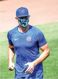  ?? AP Photo/Kamil Krzaczynsk­i ?? ■ LEFT: Chicago Cubs third baseman Kris Bryant warms up during baseball practice Sunday at Wrigley Field in Chicago.