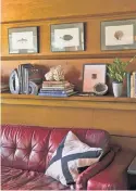  ??  ?? In the study, wood shelving remains — topped with Wright-themed books the Cretellas collect.