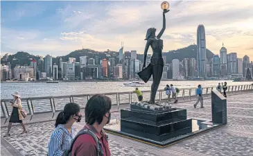  ?? ?? SHARPENING THEIR SCISSORS : A sculpture commemorat­ing the Hong Kong Film Awards stands in Tsim Sha Tsui district of Hong Kong.