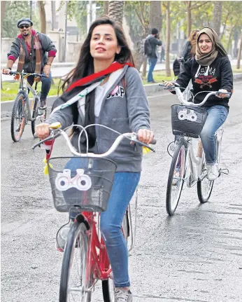  ??  ?? PEDAL POWER: Marina Jaber rides a bicycle during an event in Baghdad in defiance of a deeply conservati­ve culture that disapprove­s of the practice.