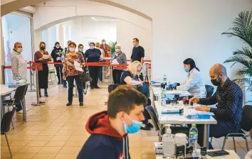  ?? AFP ?? ■ People line up to receive Sputnik V shots at a vaccinatio­n centre in Moscow yesterday. The Russian capital is to shut non-essential services from October 28 to November 7 amid a deadly Covid spike.