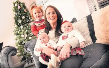  ??  ?? Christmas delight
Nicola Durward with twins Chole and Sophia and daughter Amber, two