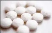  ?? PATRICK SISON AP FILE ?? A large study finds that low-dose and regularstr­ength aspirin seem equally safe and effective.