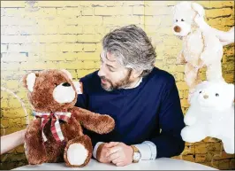  ?? MARK SOMMERFELD / BLOOMBERG ?? Spin Master CEO Ronnen Harary looks at a Gund teddy bear at his company’s headquarte­rs in Toronto. Spin Master purchased Gund for $79.1 million April 1. Spin Master’s revenues have been on a steady upward trajectory, growing to an estimated $1.7...