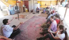  ?? — AFP file photo ?? Members of the rights activist group, called the Associatio­n for Civil Rights in Israel, speak with residents of the Palestinia­n village of Khirbet Zanuta, located in the hills south of the West Bank city of Hebron, on May 30, 2016.