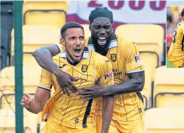  ?? ?? Star man Cristian Montano (left) celebrates after putting Livingston on the road to victory