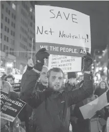  ?? SCOTT EISEN/BLOOMBERG ?? People gather in support of net neutrality in Boston on Thursday. Millions of Americans and the Democrats oppose the proposal to drop it as they fear telecom giants could gain more power.