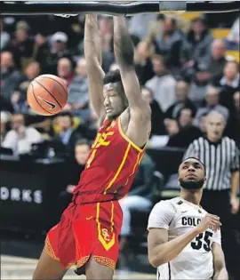  ?? David Zalubowski Associated Press ?? THE TROJANS’ Chimezie Metu dunks in front of Colorado’s Dallas Walton during the first half. A 12-0 spurt in the waning minutes keyed the Trojans.