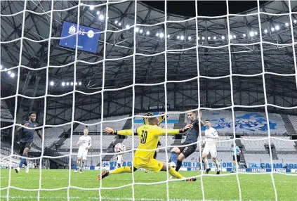  ?? PHOTO: GETTY IMAGES ?? Net gain . . . Ferran Torres, of Manchester City, scores his side’s first goal during the Uefa Champions League group C match against Olympique de Marseille at Stade Velodrome in Marseille yesterday. Fans were barred from attending because of the Covid19 pandemic.