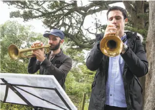  ?? Photos by Amy Osborne / Special to The Chronicle ?? Trumpet players Tom Pagano and Max Miller, above, and actors John Steele Jr. and Britt Lauer, at left, rehearse for an outdoor, site-specific adaptation of “Midsummer of Love” on Strawberry Hill in Golden Gate Park.