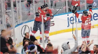  ?? BRYNN ANDERSON THE ASSOCIATED PRESS ?? Florida’s Troy Brouwer and Denis Malgin celebrate with captain Aleksander Barkov after a Barkov goal.