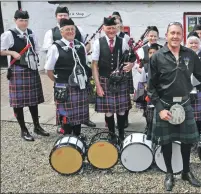  ??  ?? Newly-married Michelle and Howard Shoquis from Calgary, Alberta, were delighted to be photograph­ed with the Arran Pipe Band after their blessing at Whiting Bay.