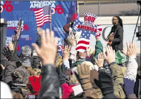  ?? TAYLOR CARPENTER / TAYLOR.CARPENTER@AJC.COM ?? The crowd raises their hands during a song at Franklin Graham’s prayer rally in February 2016. Religious leaders and groups have regularly engaged in political speech, generic and specific.