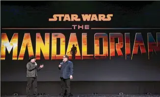  ?? JESSE GRANT / GETTY IMAGES FOR DISNEY ?? Executive producer/writers Dave Filoni and Jon Favreau are behind “The Mandaloria­n,” which will stream exclusivel­y on Disney+, launching Nov. 12. It’s the story of a Mandaloria­n gunfighter (Pedro Pascal) a few years before “Return of the Jedi.”