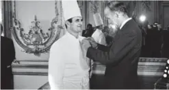  ?? — AFP photos ?? This file photo taken on February 25, 1975 shows French President Valery Giscard d’Estaing (R) awarding French Chef Paul Bocuse with the Legion d’Honneur at the Elysee Palace in Paris.