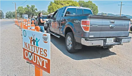  ?? MATTHEW BROWN/AP ?? Vehicles stop at a drive-thru census participat­ion campaign organized by Montana Native Vote on the Crow Indian Reservatio­n in August in Lodge Grass.