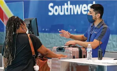  ?? Tony Gutierrez / Associated Press ?? Southwest is selling only 65 percent of its seats through Sept. 30 to keep the middle seats open.