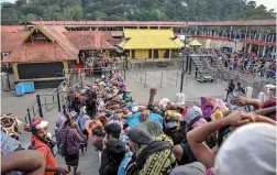  ?? — PTI ?? Devotees arrive at the Sabarimala temple in Kerala’s Pathanamth­itta district on Monday. This is the second time the hill shrine opened for “darshan” after the Supreme Court allowed the entry of women of all age groups.