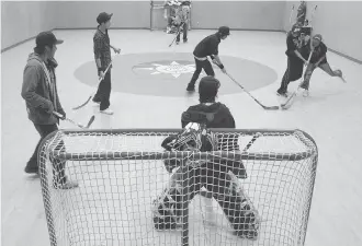  ?? JON THOMPSON ?? Students play floor hockey in Pikangikum­ís new gymnasium in 2011. It was converted to a courtroom the next day. Research shows that youth report an increase in resilience when they are brought together for cultural activities.