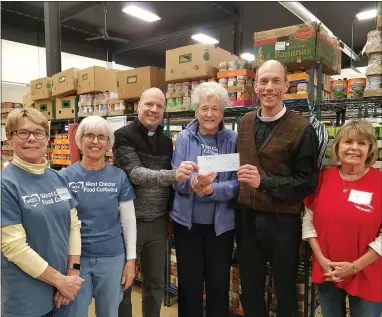  ?? SUBMITTED PHOTO ?? Pastor Christophe­r J Franz of Advent Lutheran and Pastor Dan Krewson of Calvary Lutheran present a $901check to the West Chester Food Cupboard, proceeds from a pick-up pickleball game.