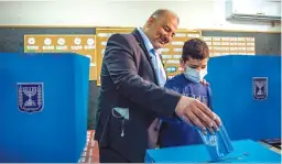  ?? (Flash90) ?? UNITED ARAB LIST leader Mansour Abbas votes in Maghar yesterday.