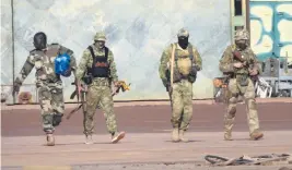  ?? AP ?? This undated photograph handed out by the French military shows three Russian mercenarie­s, right, in Mali, where insurgents have overrun vast stretches of the country.