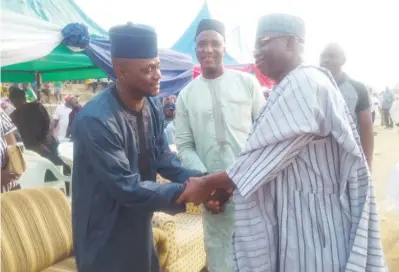  ??  ?? Chairman of Abaji area council, Alhaji Abdulrahma­n Ajiya (left) shakes hands with APC chieftain , Usman Jibrin Wowo, while FCT APC chairman, Usman Abdulmalik, looks on, during the party's event in Kuje weekend.