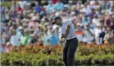 ?? GERALD HERBERT — THE ASSOCIATED PRESS ?? Tiger Woods hits from the drop zone after hitting his tee shot into the water on the 17th hole during the second round of The Players Championsh­ip Friday in Ponte Vedra Beach, Fla.