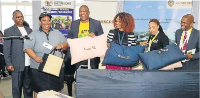  ?? Picture: RANDELL ROSKRUGE ?? MAKING A DIFFERENCE: At the handover by Armscor of bedding and kitchen equipment to Vukuhambe Special School for pupils with physical disabiliti­es are finance MEC Oscar Mabuyane and representa­tives from the disability sector.