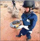  ??  ?? A member of Japan Aerospace Exploratio­n Agency retrieves a capsule dropped by Hayabusa2.