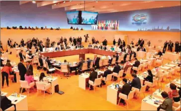  ?? LUDOVIC MARIN/AFP ?? Participan­ts of the G20 take their seats at the beginning of their third working session of the G20 meeting in Hamburg, Germany, on Saturday. The G20 needs to make three decisive actions to become a guardian of global welfare.