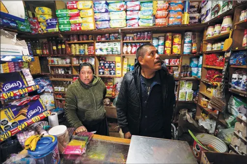  ?? (AP/Fernando Llano) ?? Jose Gonzalez and his wife Maria wait for customers Jan. 19 in their corner shop — which he remodeled, stocked and extended with money he earned over a decade working in the United States — in the Purepecha Indigenous community of Comachuen, Michoacan state, Mexico.