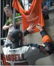  ?? NEWS PHOTO RYAN MCCRACKEN ?? Medicine Hat Tigers captain Mark Rassell signs an autograph for a young fan Feb. 13.