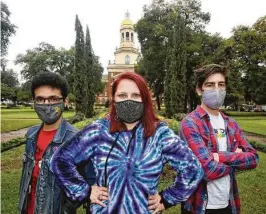  ?? Jerry Larson / Waco Tribune Herald ?? Gamma Alpha Upsilon members Alex Gonzalez, Shley Nitsche and Jake Picker stand in front of Baylor University’s Pat Neff Hall.