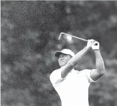  ?? Charlie Riedel/Associated Press ?? ■ Tiger Woods hits from the first fairway during a practice round for the PGA Championsh­ip golf tournament Tuesday at Bellerive Country Club in St. Louis.