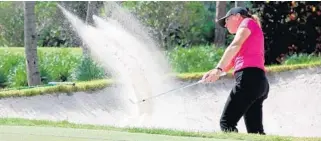  ?? STEVE WATERS/STAFF ?? Meghan Stasi of Oakland Park, a two-time champion, hits out of a bunker during her round of 74 on Saturday. She was the only player to break 80 under difficult conditions.